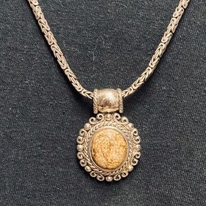 Silver and tan stone pendant